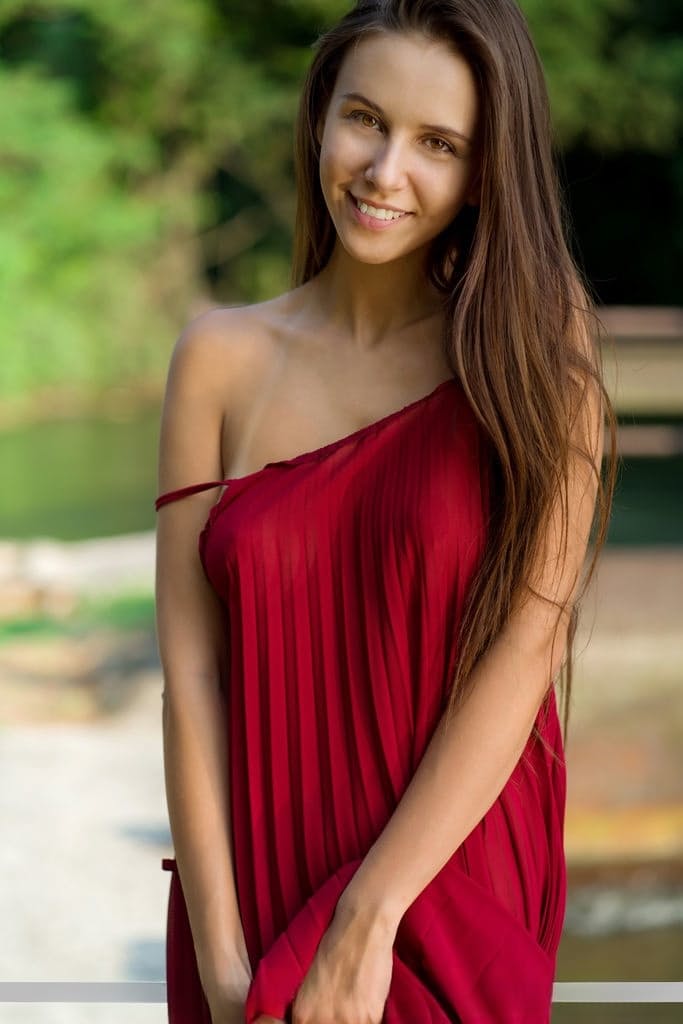 Beautiful teen Alisa Amore disrobes for nude solo poses near a dam