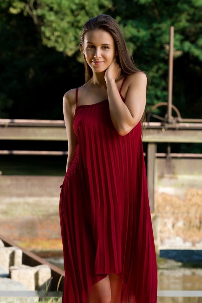 Beautiful teen Alisa Amore disrobes for nude solo poses near a dam