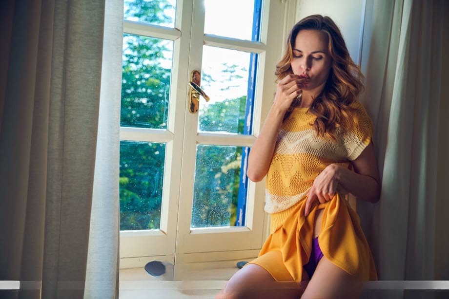 Nice teen Nasita undresses on her bed for nude poses on a window sill