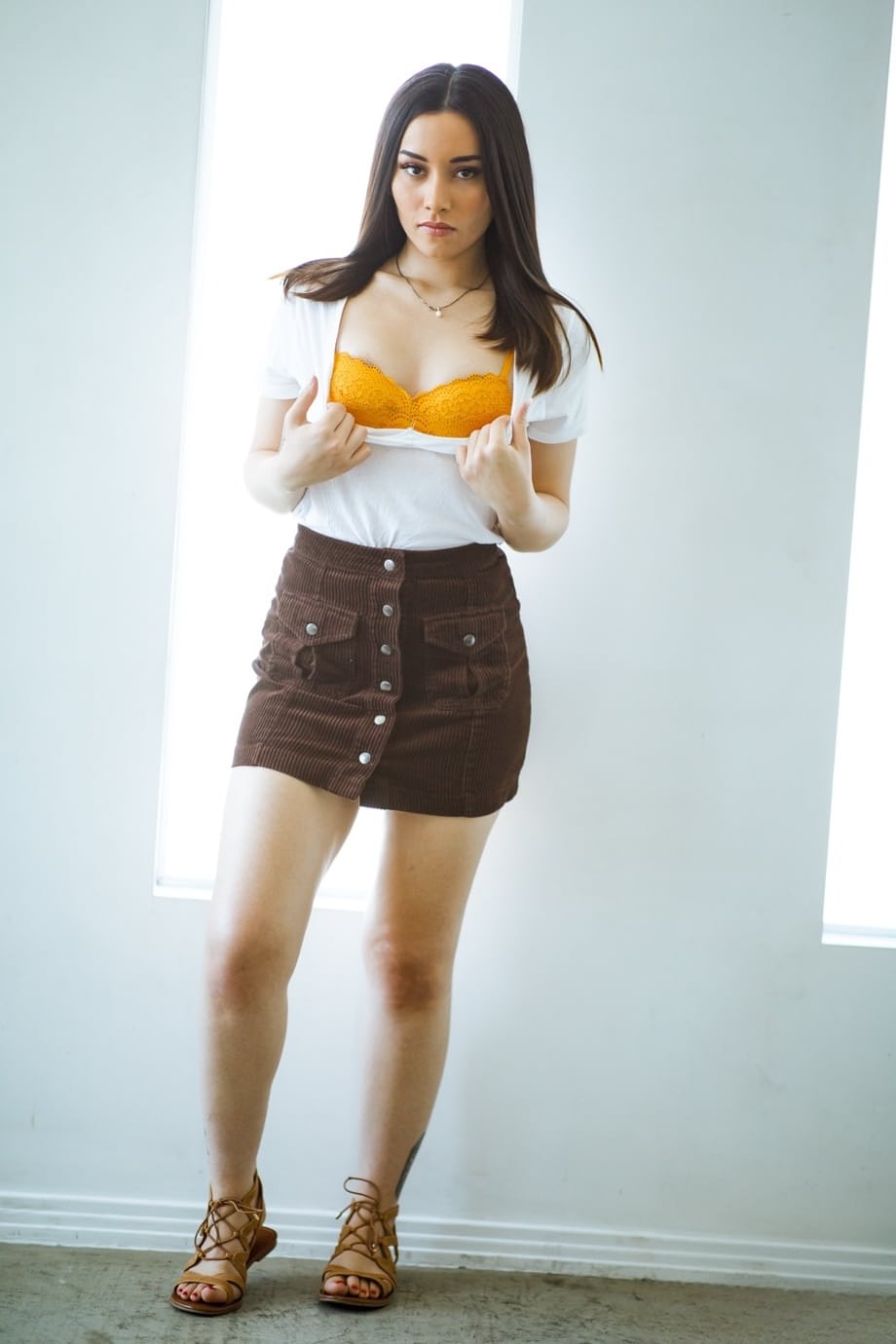 Hot brunette teen uncovers her tiny tits before showing her naked booty