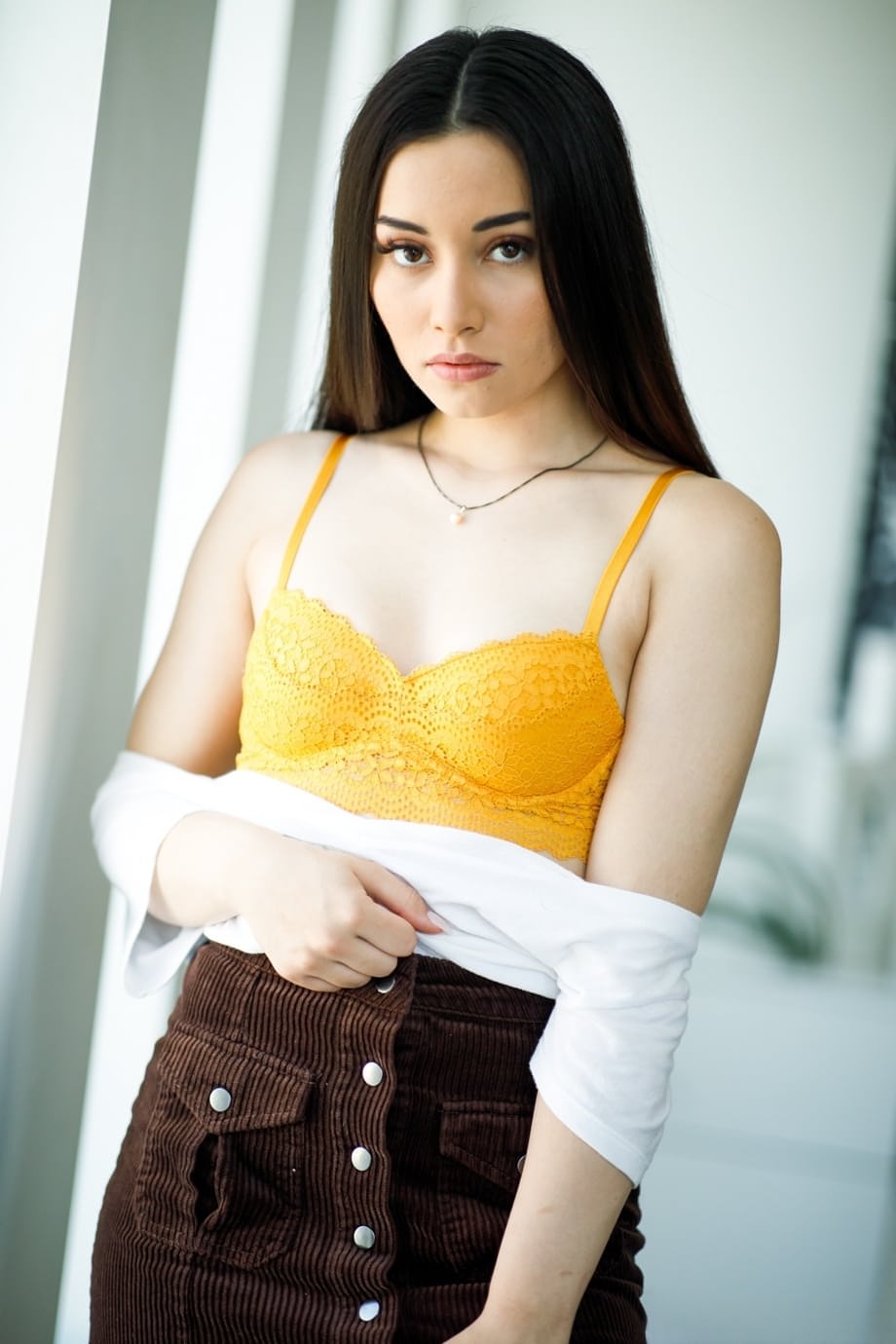 Hot brunette teen uncovers her tiny tits before showing her naked booty