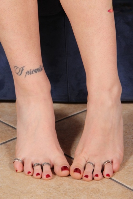 Clothed woman sniffs her flat shoes before showing her pretty feet