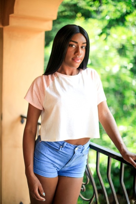 Young ebony girl touts her hot ass after getting naked on a balcony