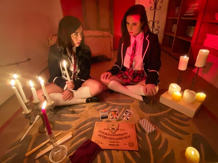 Naughty schoolgirls suck off a big black cock after consulting the Ouija board