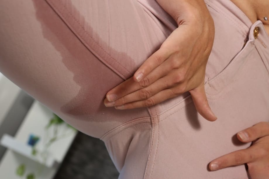 Natural blonde Delphine wets herself in leggings before a masturbation session