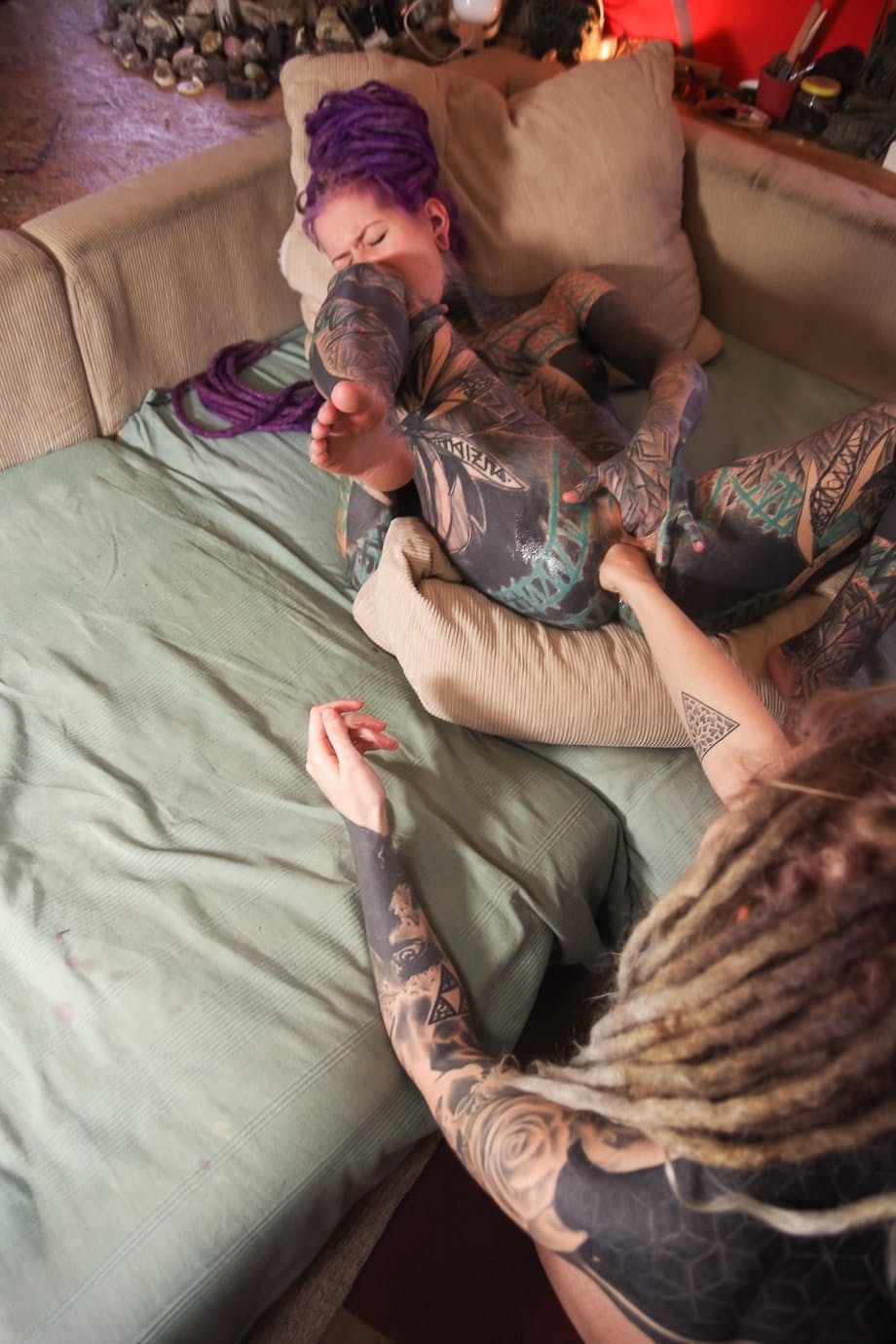 Heavily tattooed girl has her gaped anus fisted by her lover