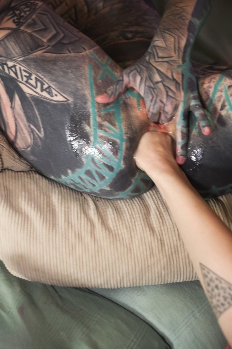 Heavily tattooed girl has her gaped anus fisted by her lover