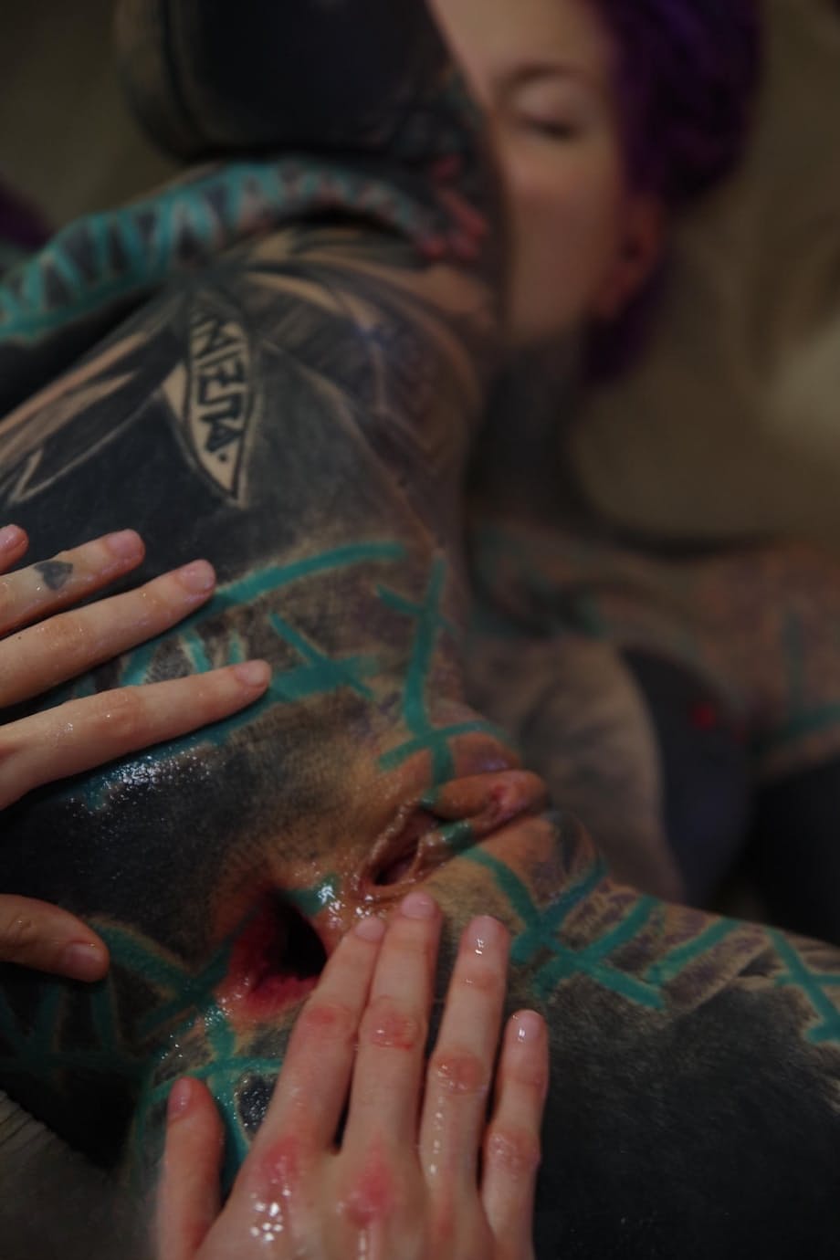 Heavily tattooed girl has her gaped anus fisted by her lover