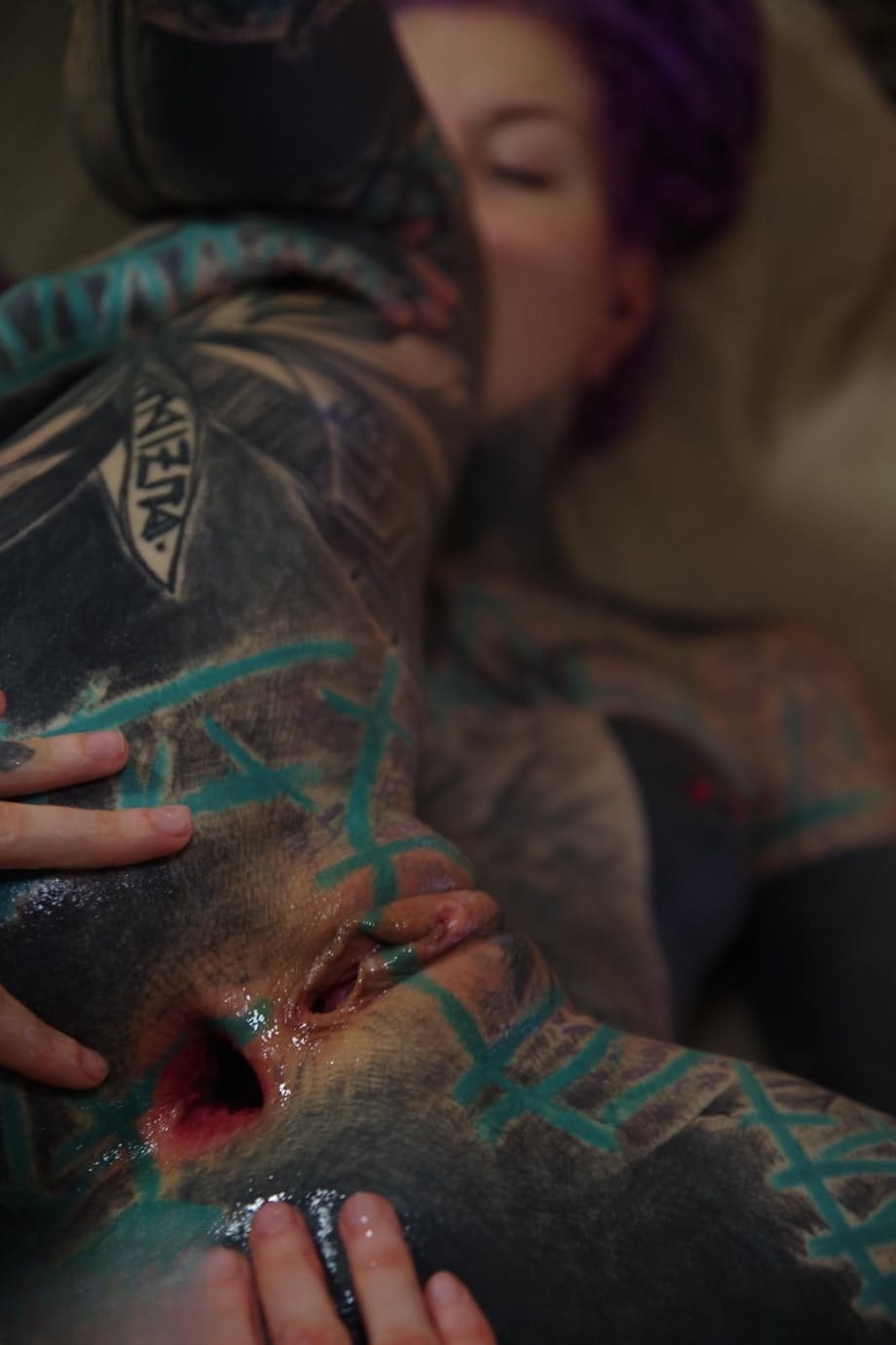 Heavily tattooed girl has her gaped anus fisted by her lover