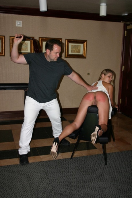 2 females with big butts get paddled overtop of BDSM benches by a clothed man