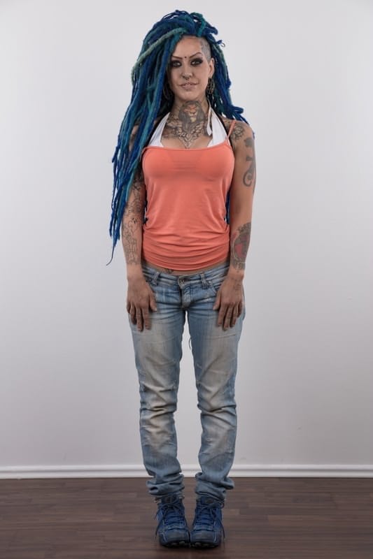 Punk girl with a headful of dyed dreads stands naked in her modelling debut