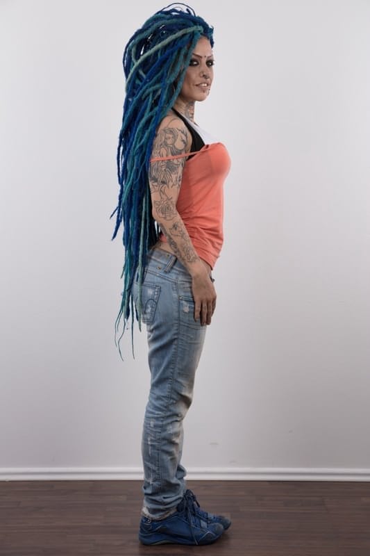 Punk girl with a headful of dyed dreads stands naked in her modelling debut