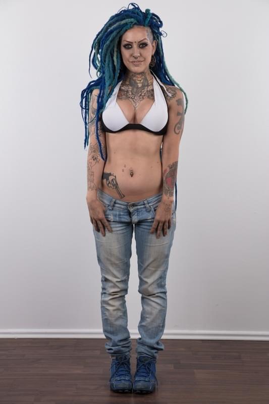 Punk girl with a headful of dyed dreads stands naked in her modelling debut