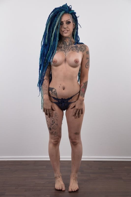 Punk girl with a headful of dyed dreads stands naked in her modelling debut