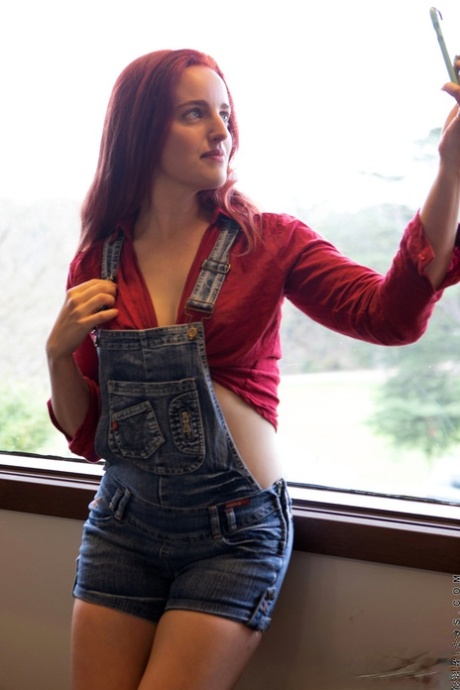 Redhead housewife Charlie Forde takes self shots while getting totally naked