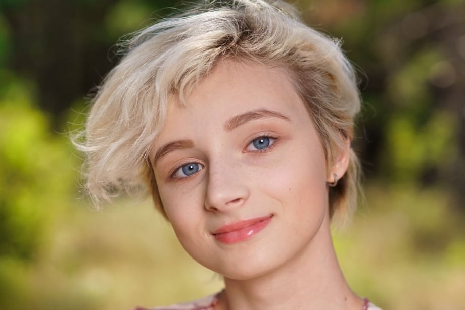 Teen girl with short blonde hair spreads her meaty labia lips in a clearing