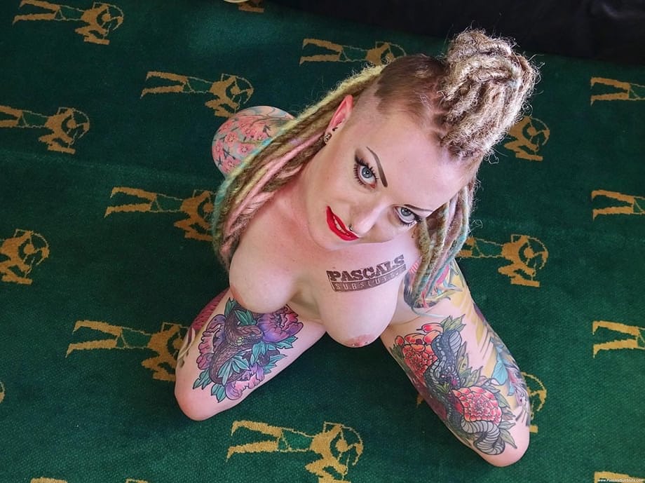 Heavily tattooed amateur Piggy Mouth removes a revealing dress to get naked