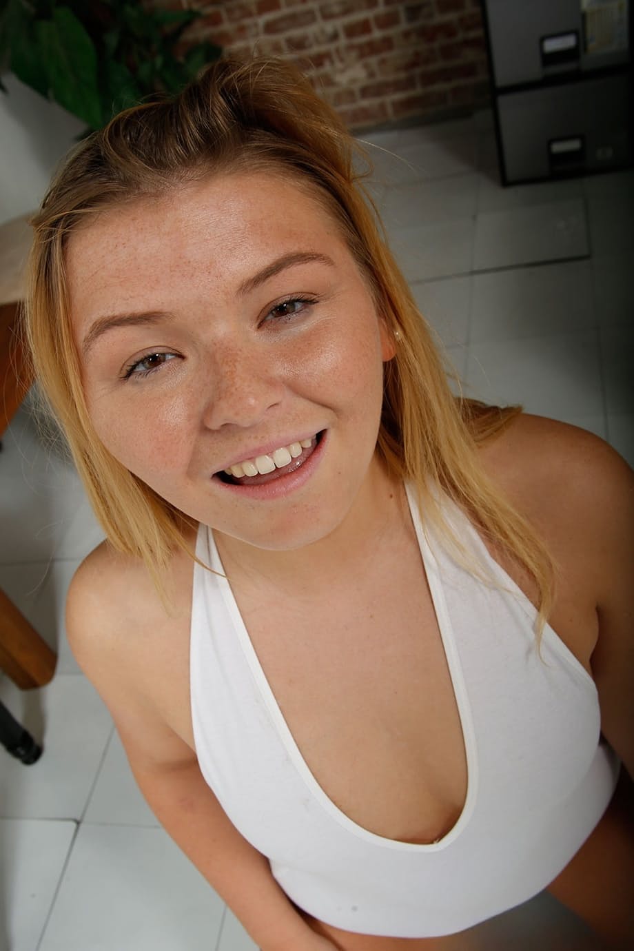 Chubby blonde strips naked before taking a long cock in her hands