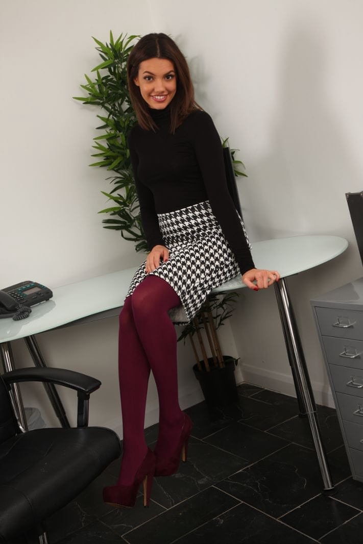 Hot secretary Abigail B bares her firm tits at work in wine toned pantyhose
