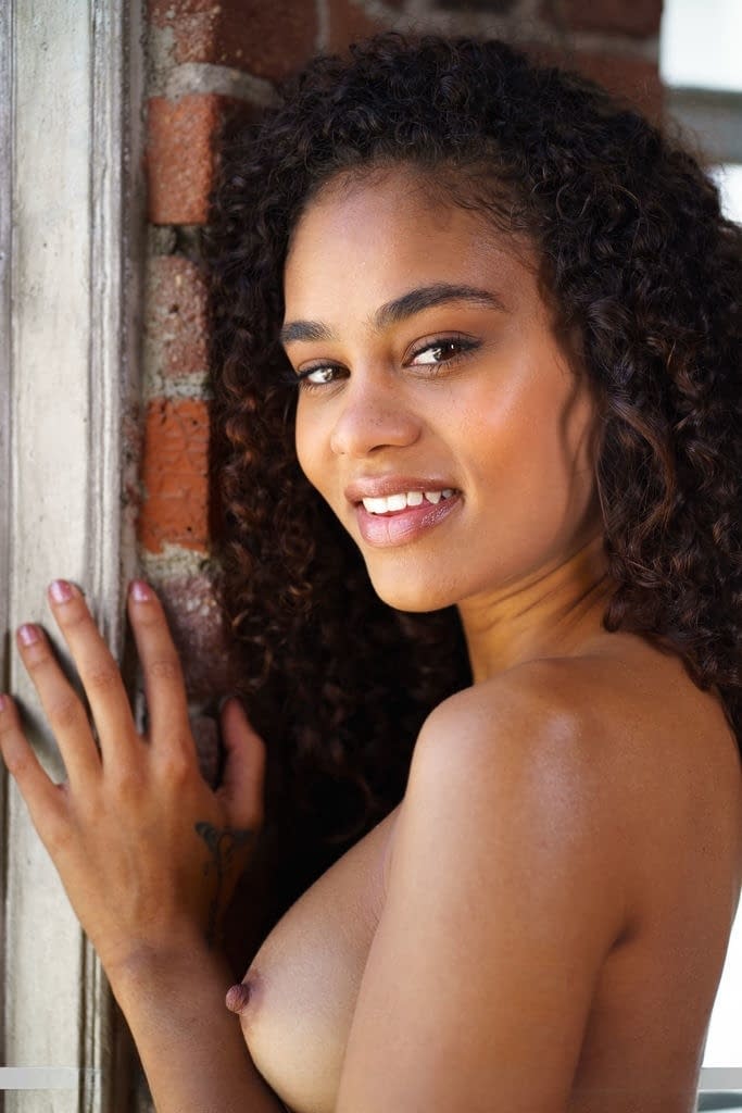 Young Latina model Scarlit Scandal sheds a dress to model nude by a window