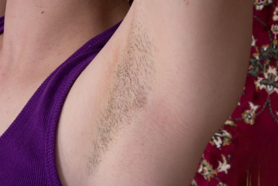 Dark haired girl with armpit stubble exposes her hairy bush