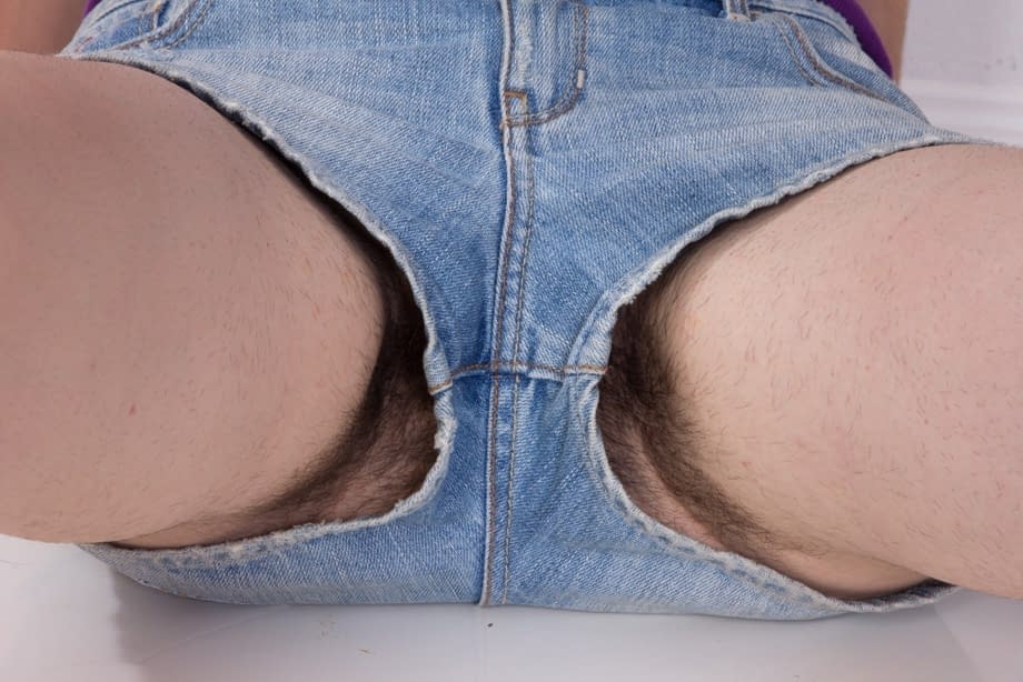 Dark haired girl with armpit stubble exposes her hairy bush