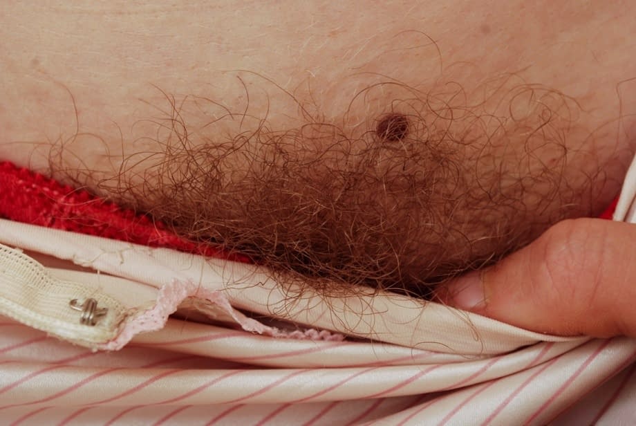 Gorgeous ginger Valcorie squats to show her hairy red pussy close up