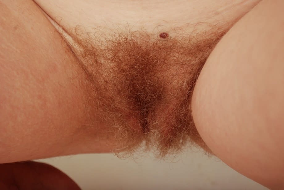 Gorgeous ginger Valcorie squats to show her hairy red pussy close up