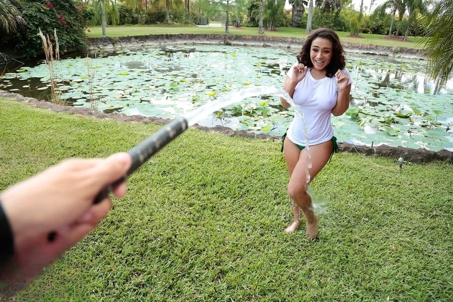 Busty Latina wets herself down in the fountain wearing a white t-shirt