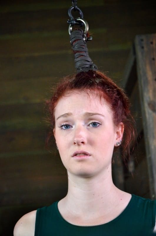 Pale redhead Ashley Lane submits to spending a day of her life in bondage