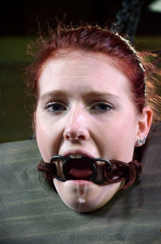 Pale redhead Ashley Lane submits to spending a day of her life in bondage
