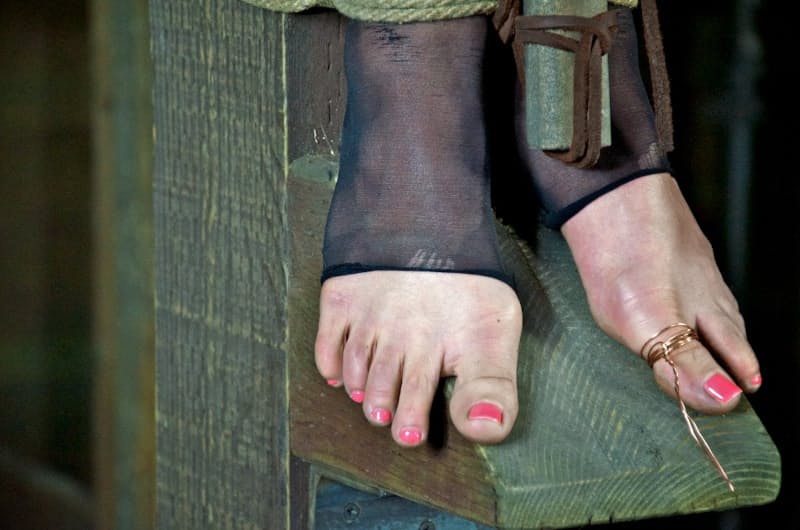 Busty slave hung on cross and tortured with tongue clip & other harsh devices