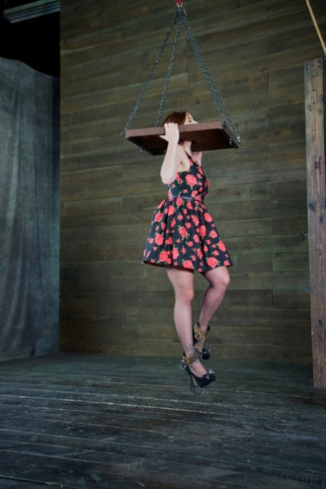 Bella Rossi is tied down and suspended in a variety of hardcore bondage poses