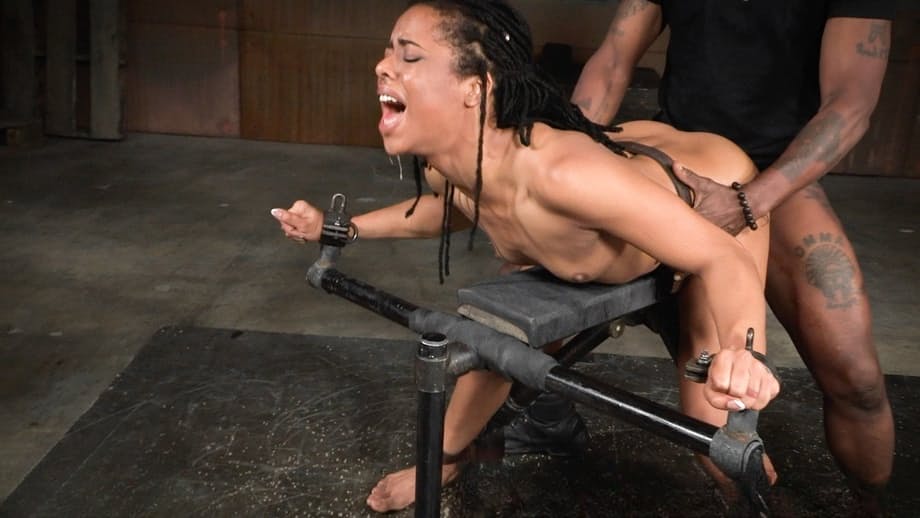 Ebony girl Kira Noir is spit roasted by black and white men in a dungeon