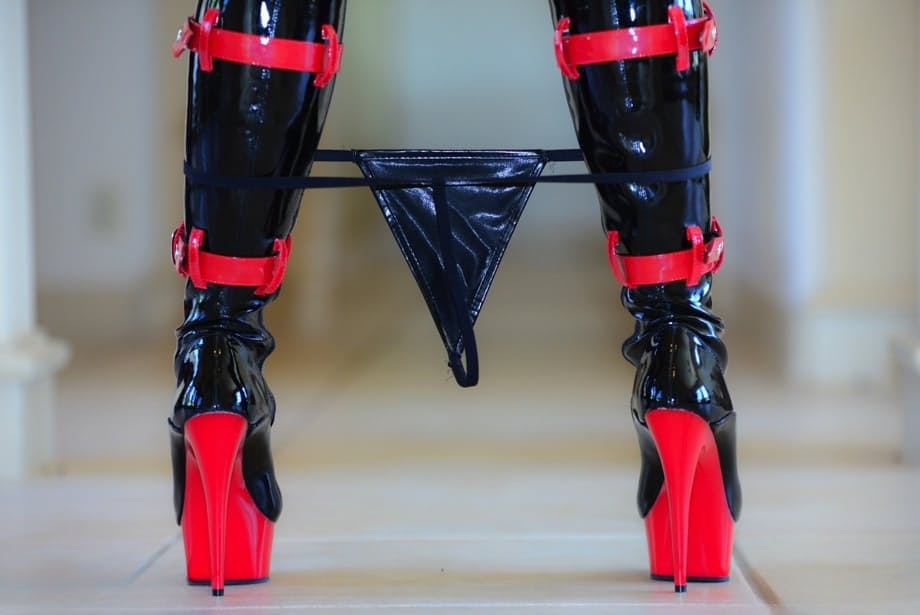 Hot redhead Lucy OHara struts her wares in latex fetish garb