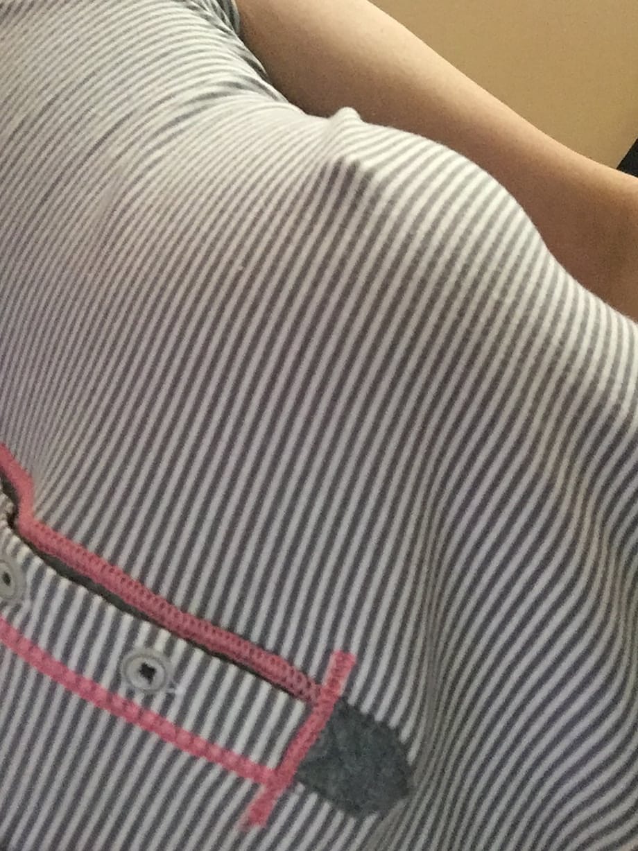 Nerdy female Amber Hahn exposes her hooters for self shots on bed