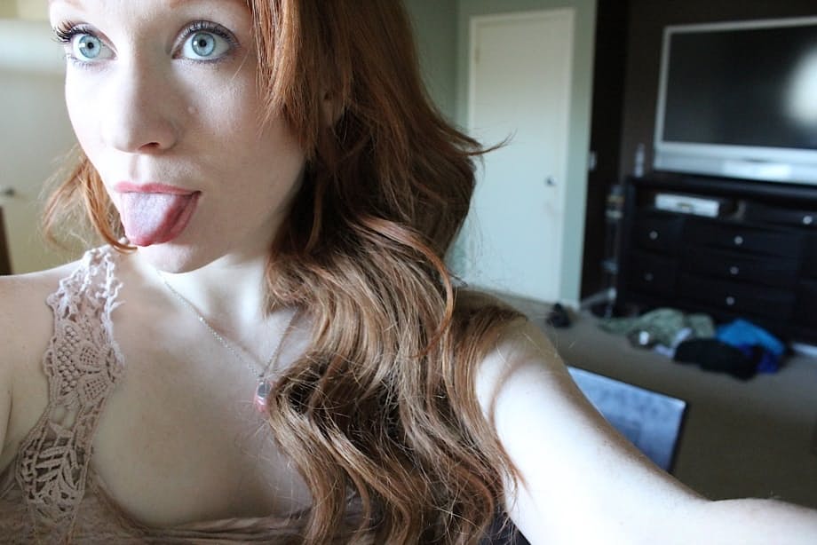 Pale redhead Lucy OHara takes selfies while fooling around on her bed on day