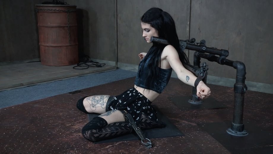 Dark haired chick Lydia Black endures facial abuse while restrained in dungeon