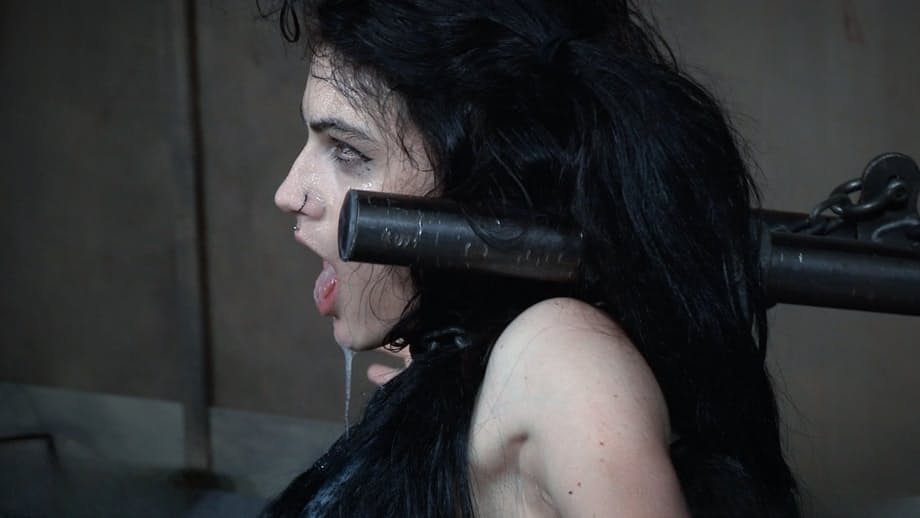 Dark haired chick Lydia Black endures facial abuse while restrained in dungeon