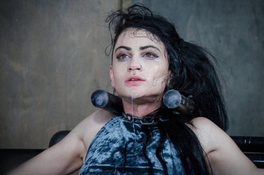 Dark haired chick Lydia Black endures facial abuse while restrained in dungeon