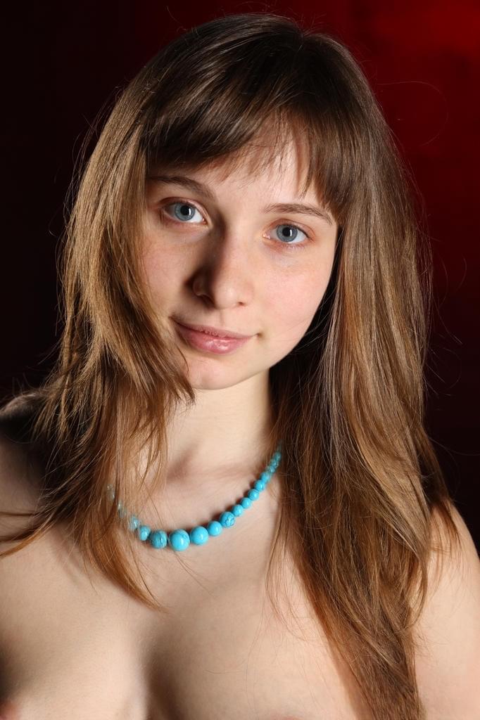 European teen Jenny D slips off blue jeans for nude posing on her bed