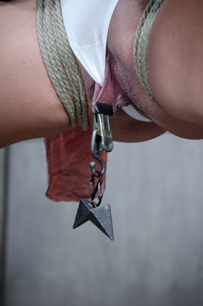 Young girl Scarlet De Sade is tied up with ropes and suspended in mid air