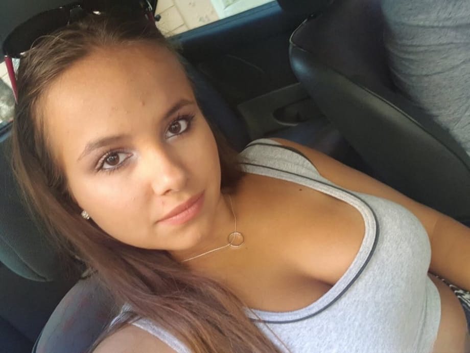 Young looking Latina girl Olivia hides her huge tits while taking selfies