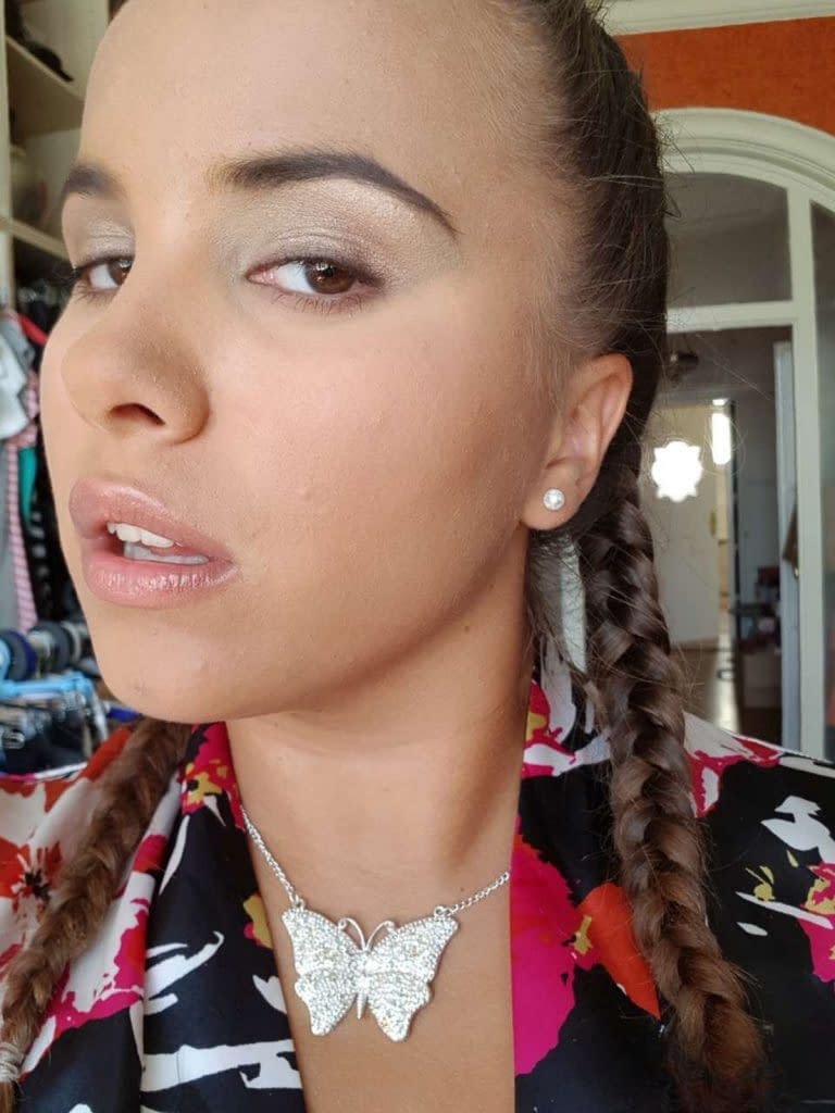 Young looking Latina girl Olivia hides her huge tits while taking selfies