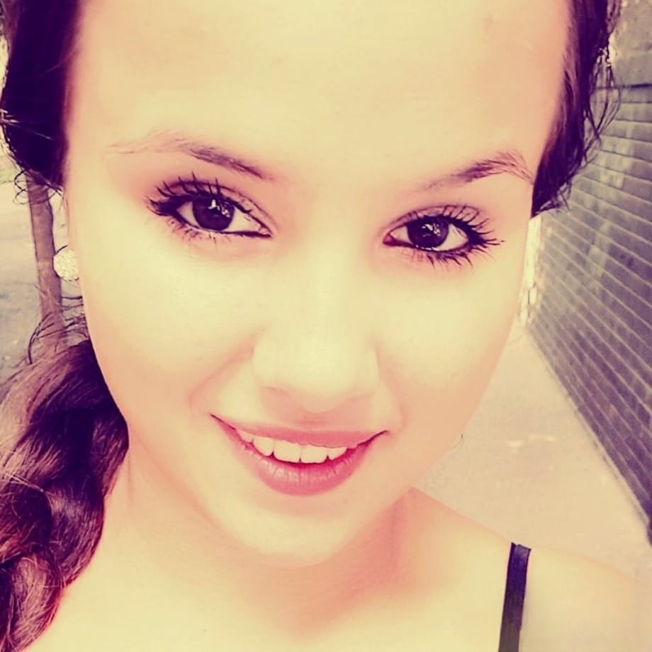 Young looking Latina girl Olivia hides her huge tits while taking selfies