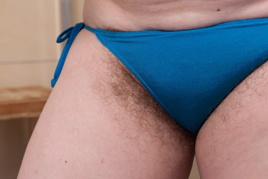 Mature fatty Romana Sweet shows off unshaven armpits and beaver in bathroom