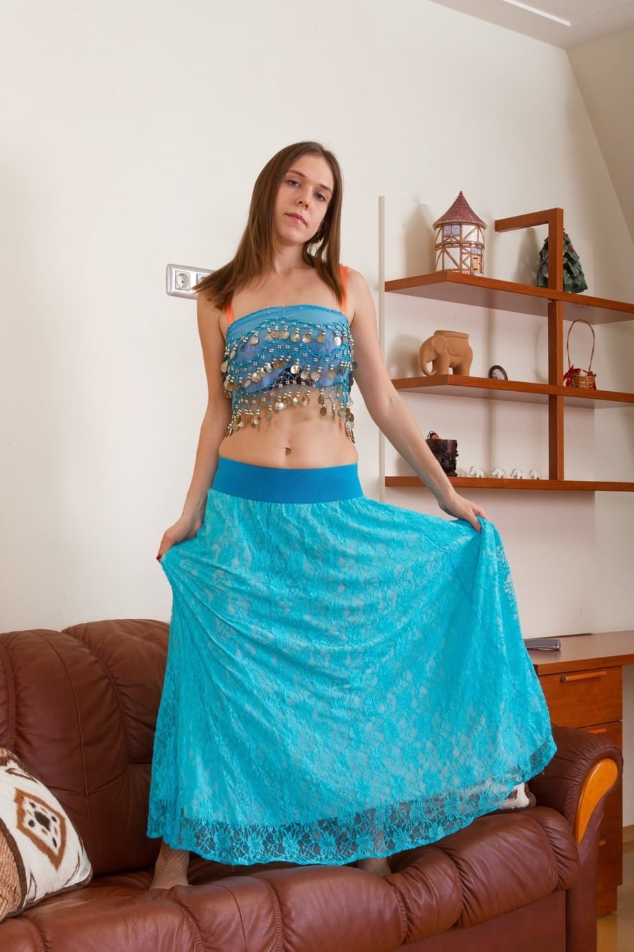 Belly dancer spreads her legs wide open to display her hairy pussy