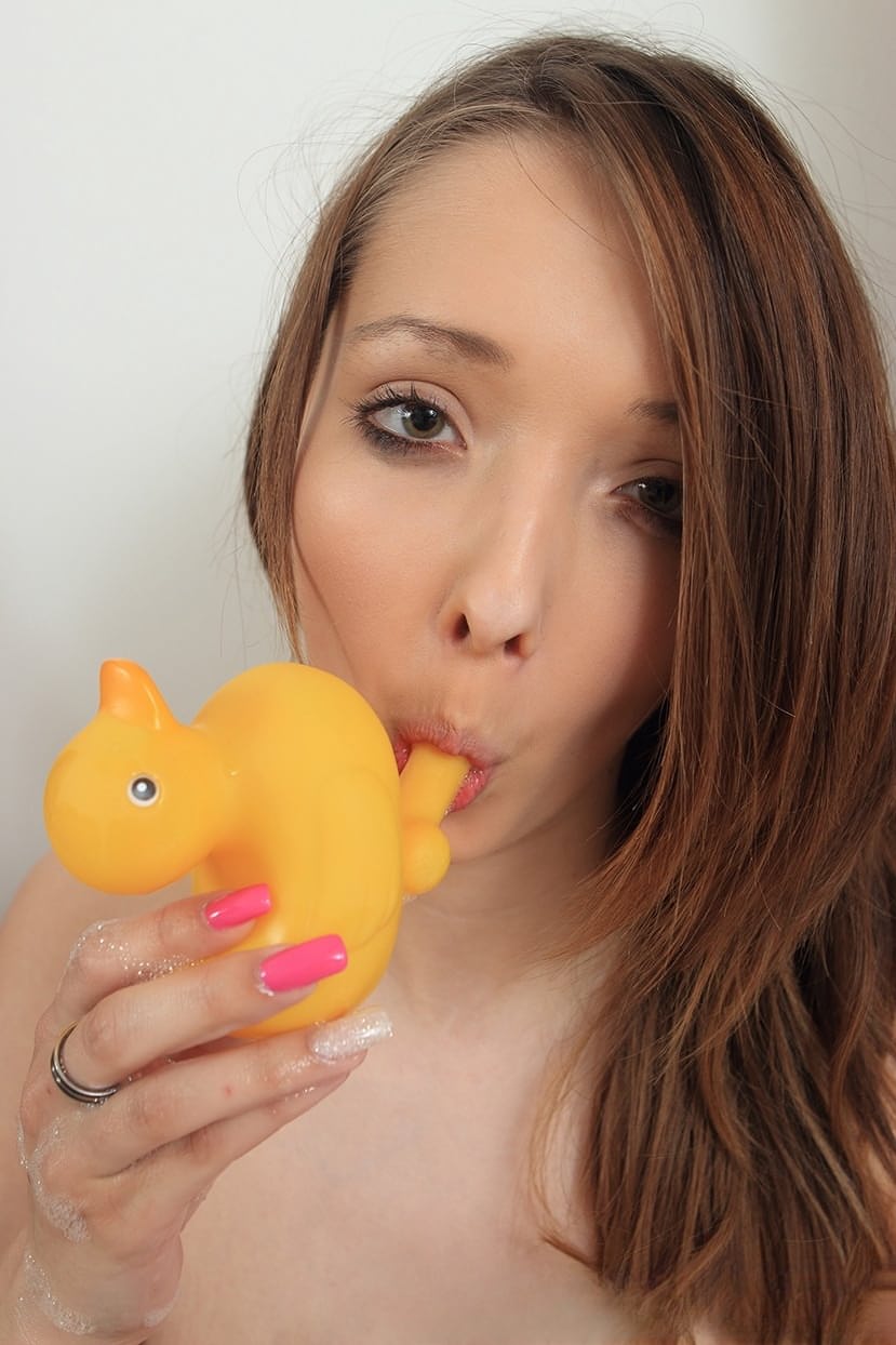 Amateur model Buffy holds a rubber duck while showing her giant breasts