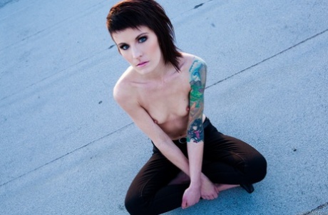 Skinny alt babe with tattooed body exposing tiny tits outdoors on rooftop