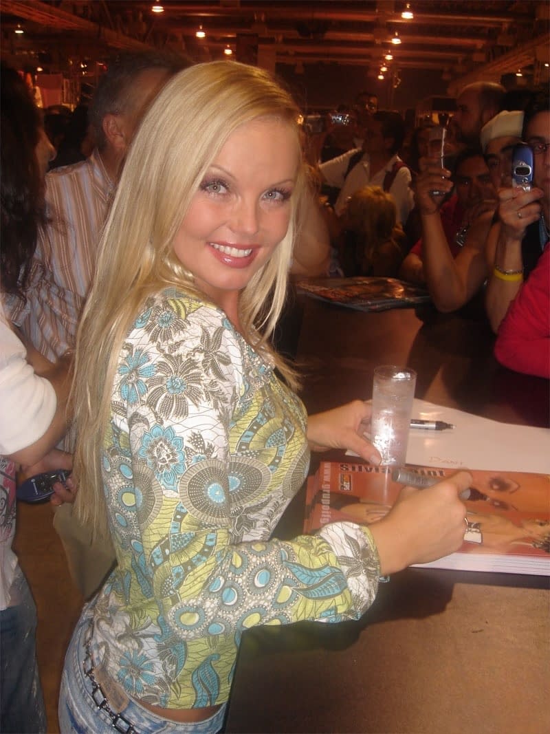 Sexy pornstar MILF Silvia Saint posing fully clothed in jeans and boots